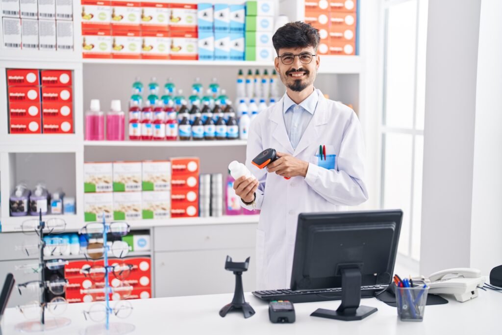 Young Hispanic Man Pharmacist Smiling Confident Scanning Pills Bottle Pharmacy 1024x683